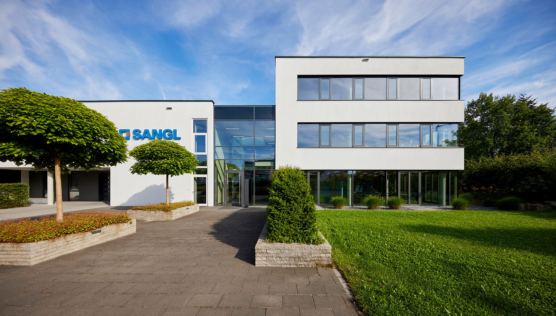 Sangl Custom Transformers headquarters with glass façade and landscaped exterior, Erlangen Tennenlohe